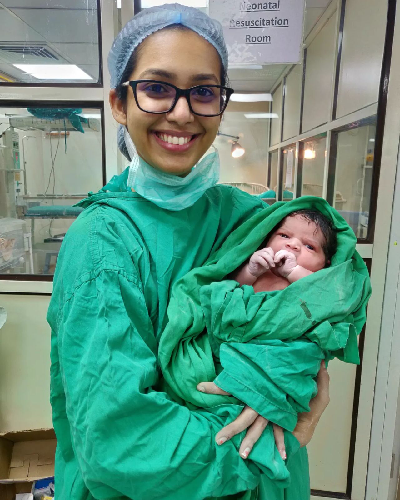 Dr. Maitreyee Athavale holding a newborn